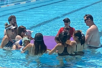 Parents and children in the pool for infant aquatics lesson at Newman Aquatic Centre