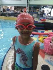 Little girl in swimming cap and goggles