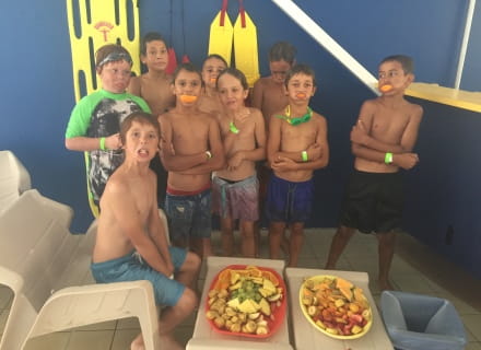 Nine boys eating from a platter of fruit after enjoying swimming lessons as part of the Go for 2 and 5 Swim for Fruit initiative at Geraldton Aquarena