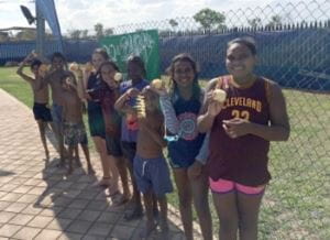 aboriginal children with slinky apples at Fitzroy Crossing pool