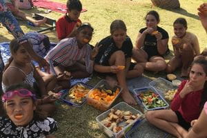 A group of children eating fruit