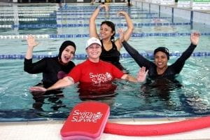 Liz Fowler in the pool with participants in a women's only swimming program