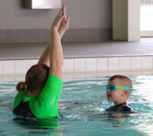 Swim Instructor Shannon with young swimmer Jaxx in the water