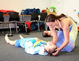 Two girls practising first aid skills