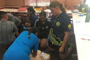 Aboriginal girls practising CPR on a manikin