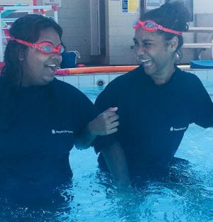 Two girls in the pool as part of the Talent Pool program at Roebourne