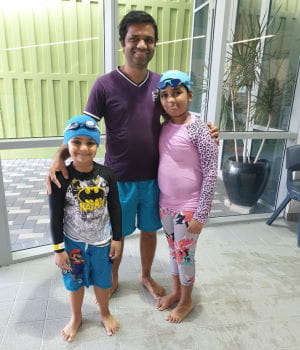 A father with his children in their swimming clothes