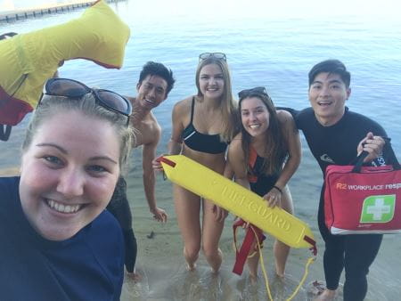 A trainer and four students with lifesaving gear having fun by the Swan River