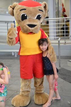 Walter with a little girl by the pool at Kwinana