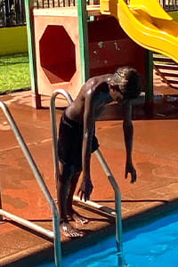 An Aboriginal boy ready to dive into the pool