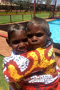 two aboriginal children hugging