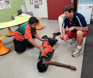 Stephen Waterman showing children the recovery position