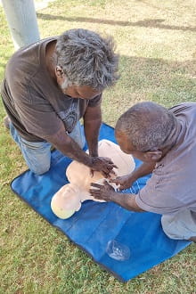 Indigenous first aid course participants practising CPR