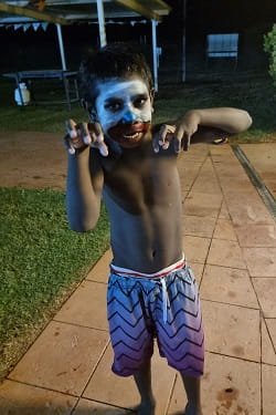 young Aboriginal boy with face painted for Halloween