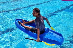 kid sitting on a kayak at the Warmun Pool