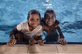 Warmun girls smiling from the pool