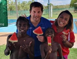 Warmun Pool Manager Steve Waterman with Aisyah from Gija Youth Program and a young Aboriginal child