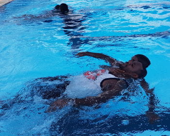 An aboriginal youth rescuing another course participant in the Warmun pool