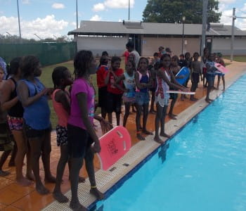 image of aboriginal children standing by the pool waiting to start a race