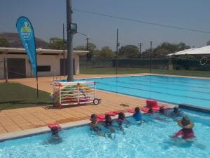 Aboriginal children in the pool at Warmun with their instructor