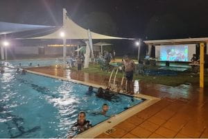 Warmun families at a night time pool party