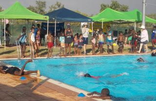 Warmun children gathered in and around the pool for their swimming carnival