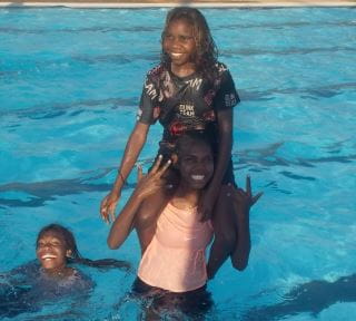 Three aboriginal girls enjoying some fun in the pool at Warmun