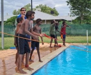 Children practising rope rescues in the pool