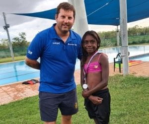 Pool Manager Stephen Waterman with an Aboriginal girl with her medal