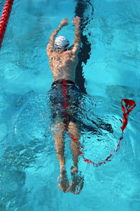 A pool lifesaver swimming underwater