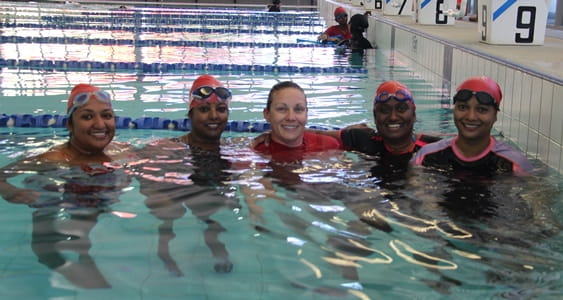 4 multicultural women with their swim instructor in the water at Cannington Leisureplex