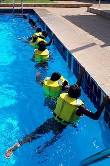 Wyndham kids wearing lifejackets in the local pool