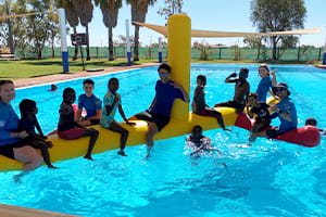Yandeyarra children enjoying a play on an inflatable in the pool
