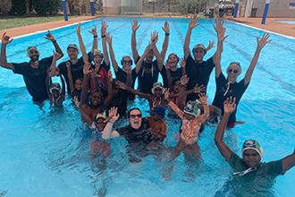 Fair Game representatives with children at Yandeyarra pool
