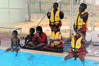 Yandeyarra kids practising wearing lifejackets at the pool
