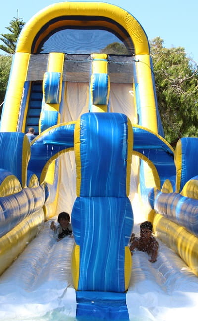 kids on a giant inflatable water slide at Bell Park in Rockingham