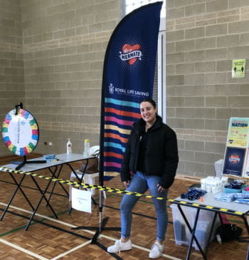 A member of our Youth Water Safety team manning a stall at a high school