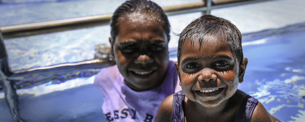 An Aboriginal toddler with his mum in the swimming pool