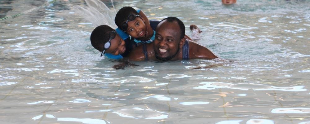a man with his two children in the water at Balga Leisureplex