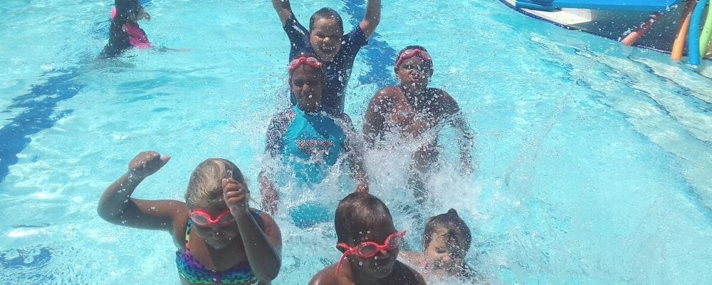 A group of Aboriginal children splashing in the water at Armadale Aquatic Centre