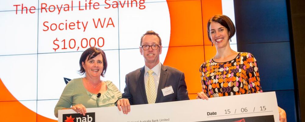Royal Life Saving Society WA's Allan Godfrey receiving a $10,000 cheque from NAB representatives