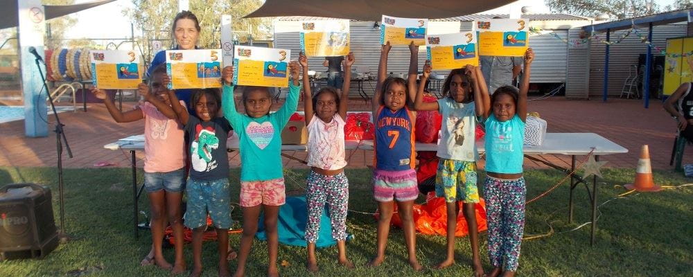 Aboriginal children hold Swim and Survive certificates at Yandeyarra pool