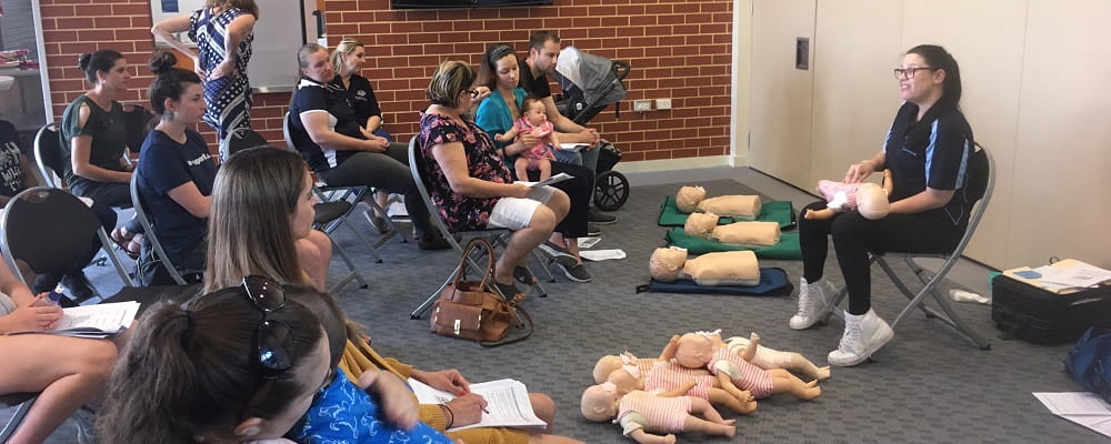 group of people learning first aid for children