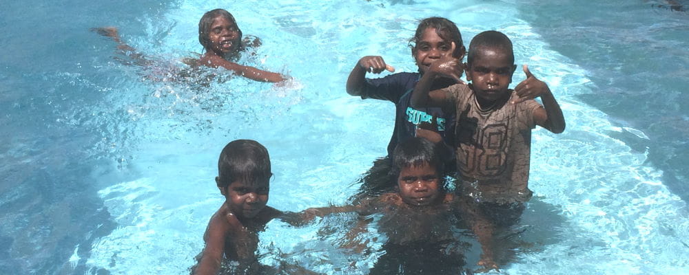 Five Aboriginal children enjoying the pool at Balgo