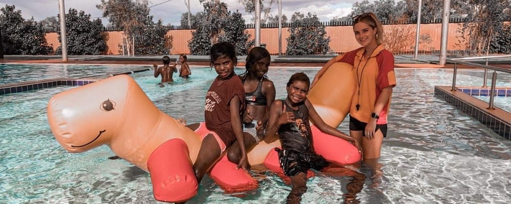 kids on an inflatable at the Balgo remote pool