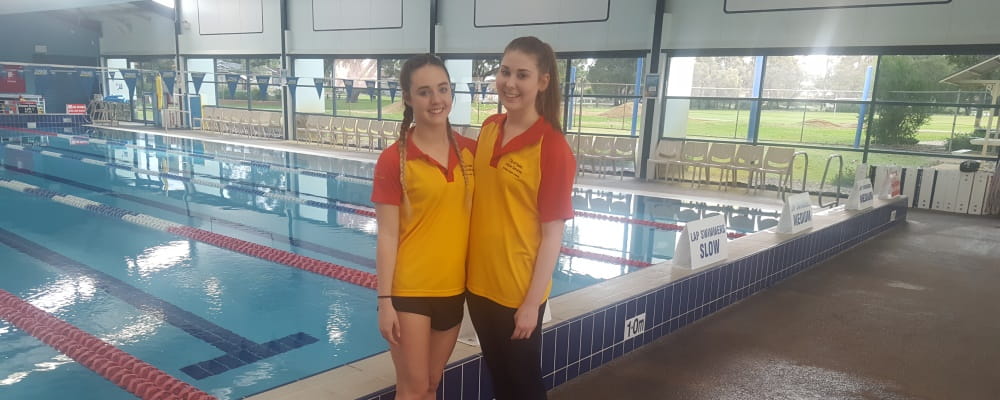 Lifeguards Jessica Colligan and Kellie Burns by the pool