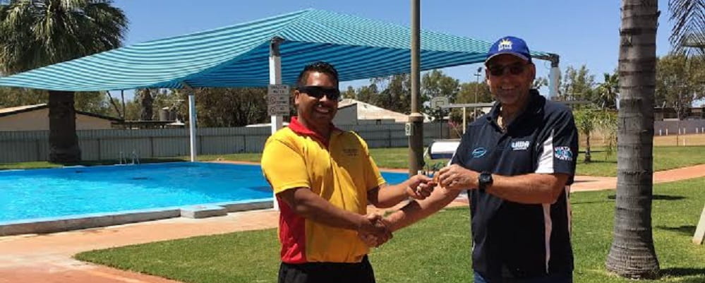 Bannister Bennell with former Laverton pool operator Ray Martin handing over the key in front of the pool
