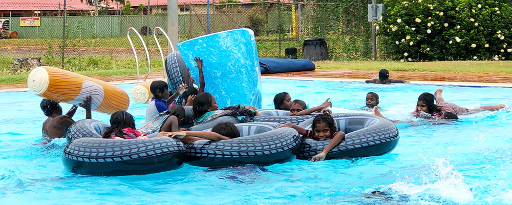 Bidyadanga children enjoying a giant pool inflatable