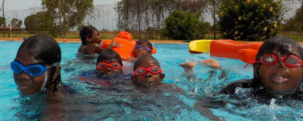 Five aboriginal children in the water at Bidyadanga pool