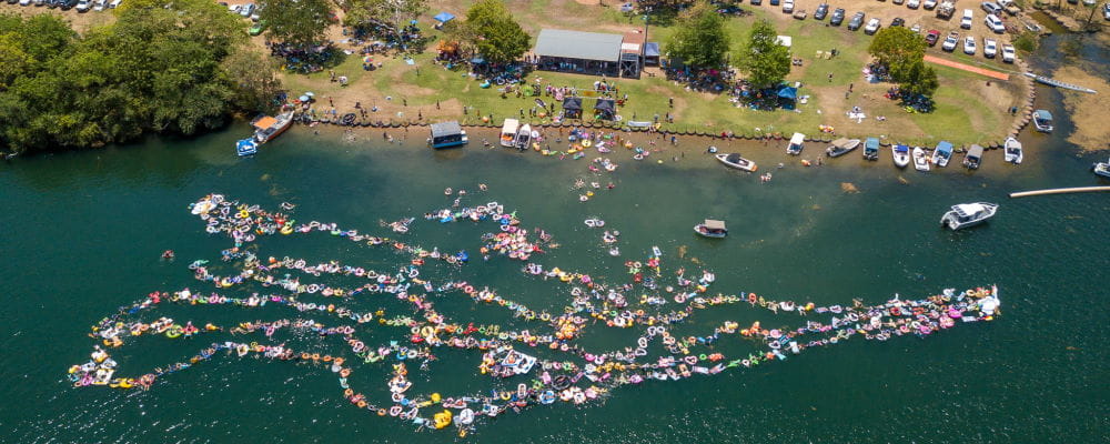 A row of people on floating in a Kununurra lake